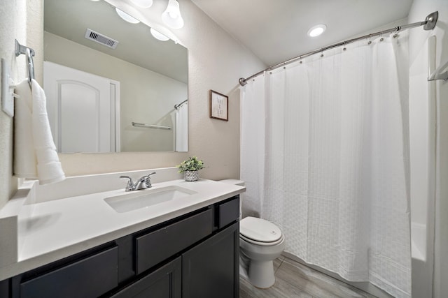 1074 Pleasant Bnd, Conroe, TX 77301 - full bathroom featuring toilet, vanity, wood finished floors, and shower / tub combo
