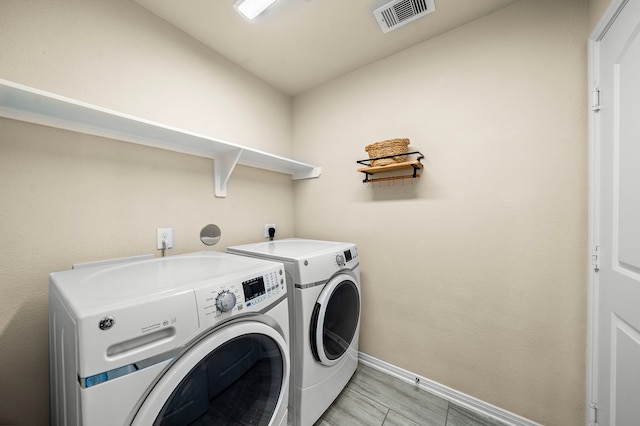 1074 Pleasant Bnd, Conroe, TX 77301 - laundry area featuring washing machine and clothes dryer and baseboards