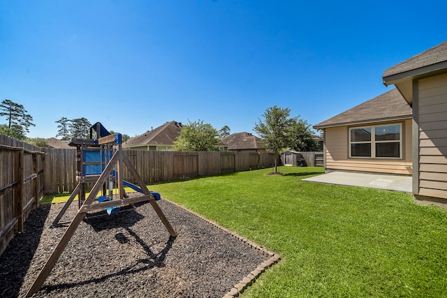 view of yard featuring a playground and a patio