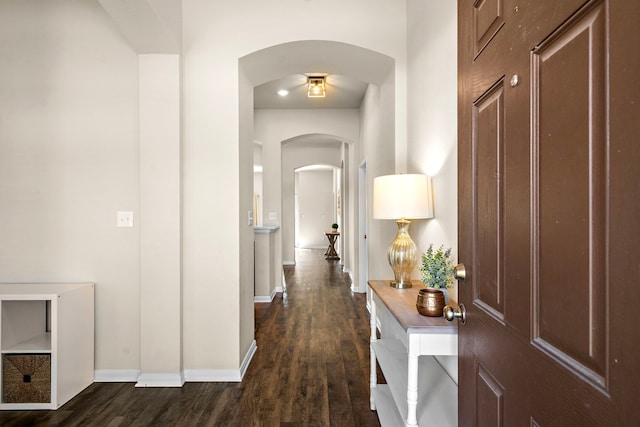 1074 Pleasant Bnd, Conroe, TX 77301 - corridor featuring arched walkways, dark wood finished floors, and baseboards