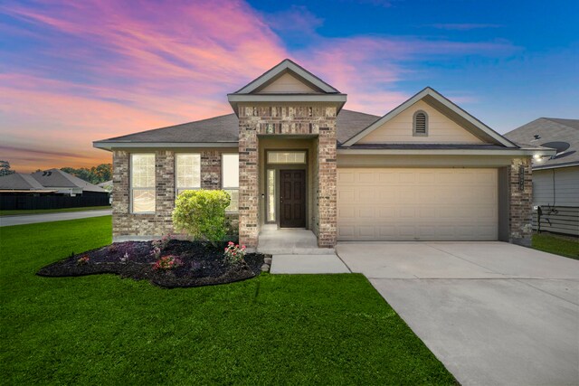 1074 Pleasant Bnd, Conroe, TX 77301 - view of front of house featuring driveway, a front yard, an attached garage, and brick siding
