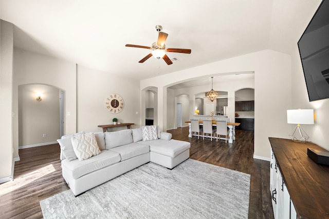 1074 Pleasant Bnd, Conroe, TX 77301 - living area featuring arched walkways, dark wood-style flooring, a ceiling fan, and baseboards