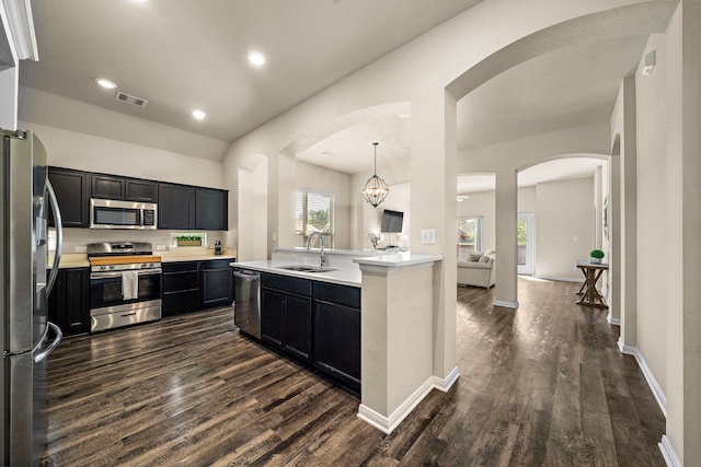 1074 Pleasant Bnd, Conroe, TX 77301 - kitchen featuring stainless steel appliances, a sink, dark cabinetry, dark wood-style floors, and recessed lighting