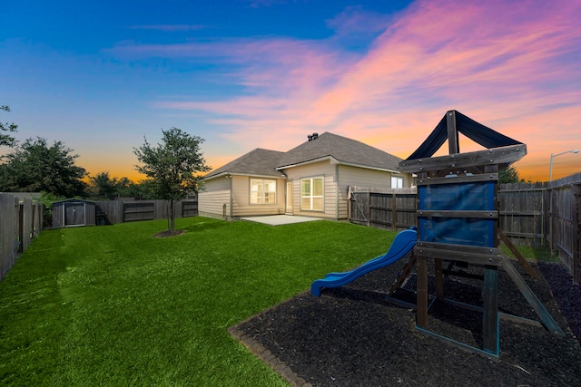 1074 Pleasant Bnd, Conroe, TX 77301 - back of house at dusk featuring a patio and a playground