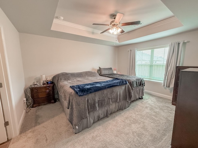 bedroom featuring visible vents, ornamental molding, light carpet, baseboards, and a raised ceiling