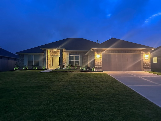 view of front facade with an attached garage, a front yard, brick siding, and concrete driveway
