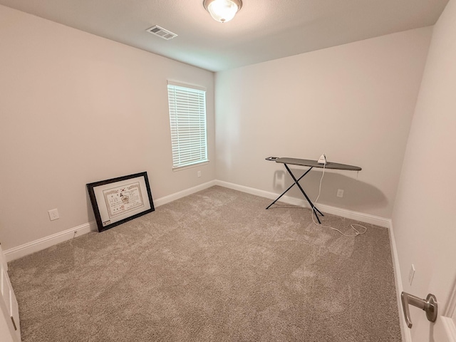 unfurnished room featuring carpet flooring, baseboards, and visible vents