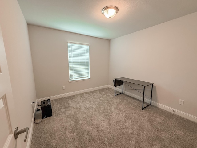 empty room with baseboards and carpet flooring