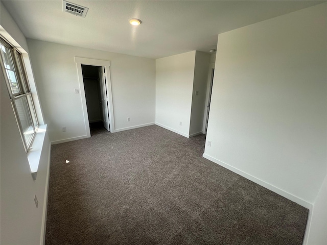 2223 Inglenook Grove Dr, Katy, TX 77493 - unfurnished bedroom featuring dark colored carpet and a walk in closet
