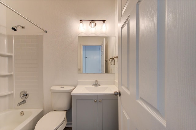 bathroom featuring vanity, bathtub / shower combination, and toilet