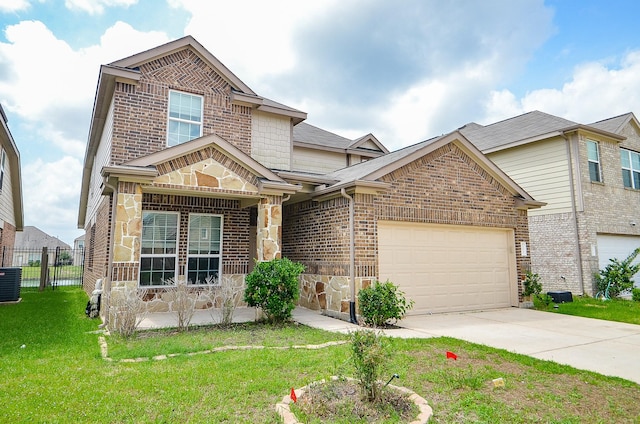 traditional home featuring a garage, fence, a front yard, stone siding, and concrete driveway