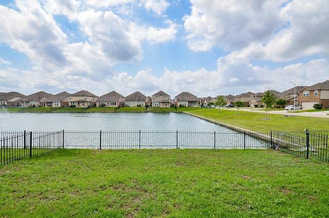 view of water feature featuring fence and a residential view