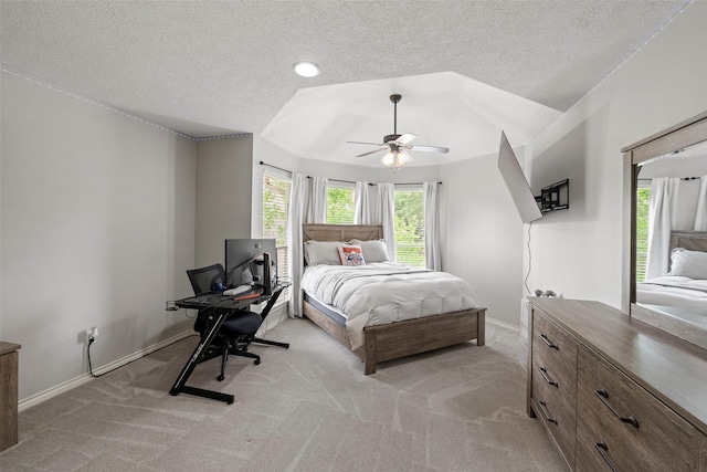 bedroom featuring baseboards, ceiling fan, light carpet, and a textured ceiling