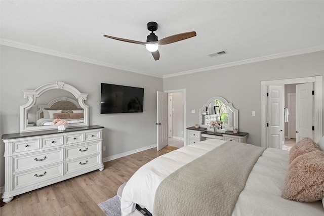 bedroom with visible vents, ornamental molding, light wood-style floors, baseboards, and ceiling fan