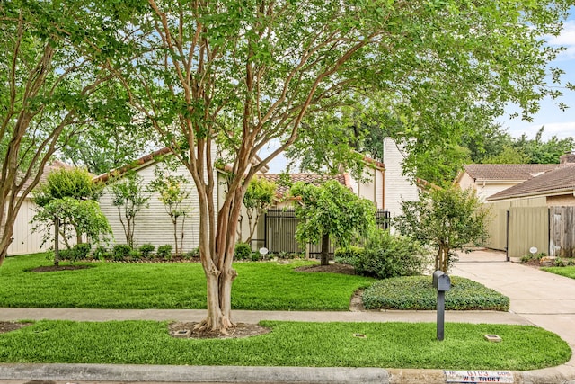 6103 Gallant Forest Dr, Houston, TX 77088 - obstructed view of property featuring fence, driveway, and a front lawn