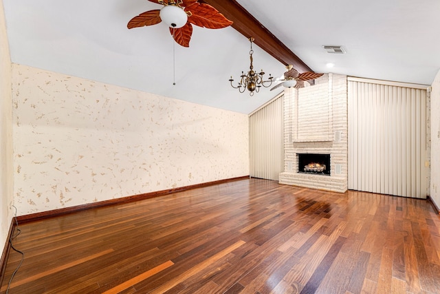 6103 Gallant Forest Dr, Houston, TX 77088 - unfurnished living room with visible vents, a brick fireplace, wood finished floors, lofted ceiling with beams, and ceiling fan with notable chandelier