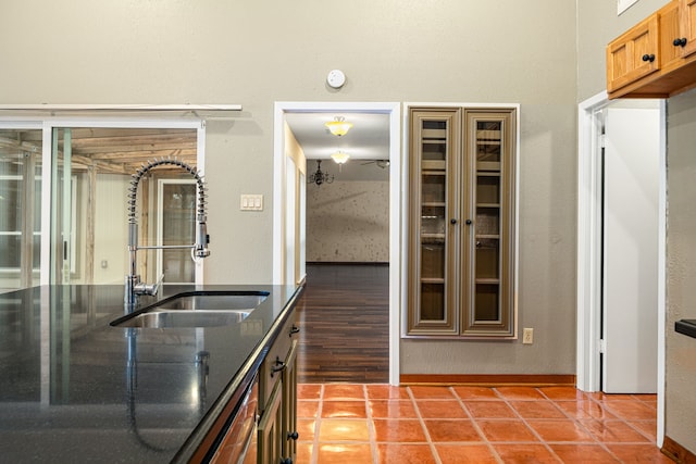 6103 Gallant Forest Dr, Houston, TX 77088 - kitchen with tile patterned flooring, a sink, dark stone counters, and baseboards