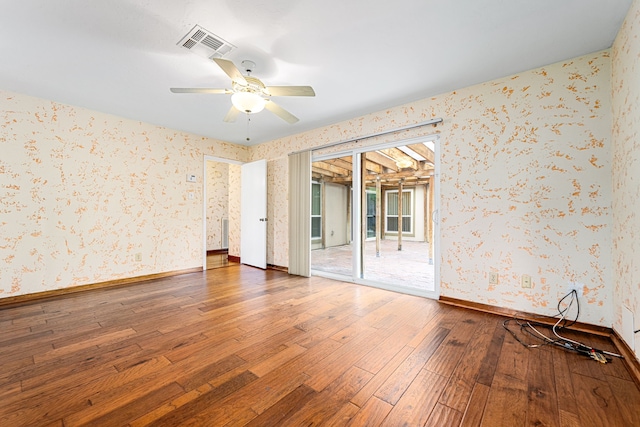 6103 Gallant Forest Dr, Houston, TX 77088 - spare room featuring wood-type flooring, a ceiling fan, wallpapered walls, baseboards, and visible vents