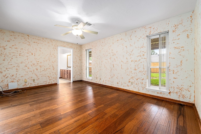 6103 Gallant Forest Dr, Houston, TX 77088 - spare room with baseboards, wallpapered walls, a wealth of natural light, and dark wood-type flooring