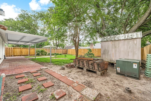 6103 Gallant Forest Dr, Houston, TX 77088 - view of yard featuring a fenced backyard, an outdoor structure, a patio, and a storage shed