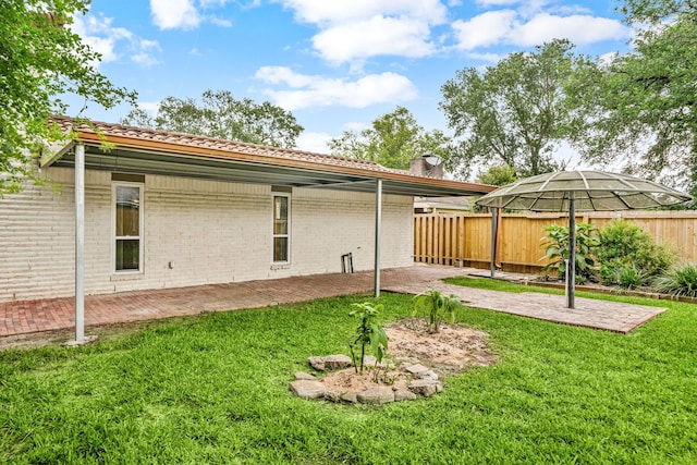 6103 Gallant Forest Dr, Houston, TX 77088 - rear view of house with a yard, brick siding, a fenced backyard, and a patio area