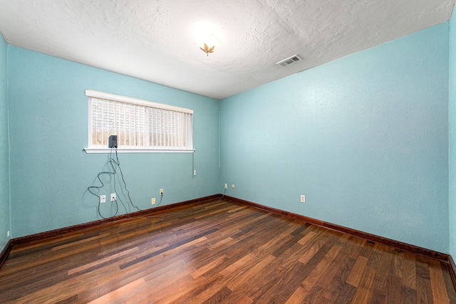 6103 Gallant Forest Dr, Houston, TX 77088 - unfurnished room with visible vents, a textured ceiling, baseboards, and wood finished floors