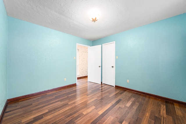 6103 Gallant Forest Dr, Houston, TX 77088 - unfurnished bedroom featuring baseboards, a textured wall, and wood finished floors