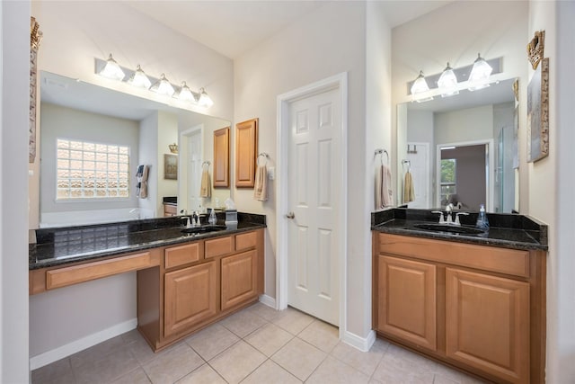 full bath with a sink, tile patterned floors, and two vanities