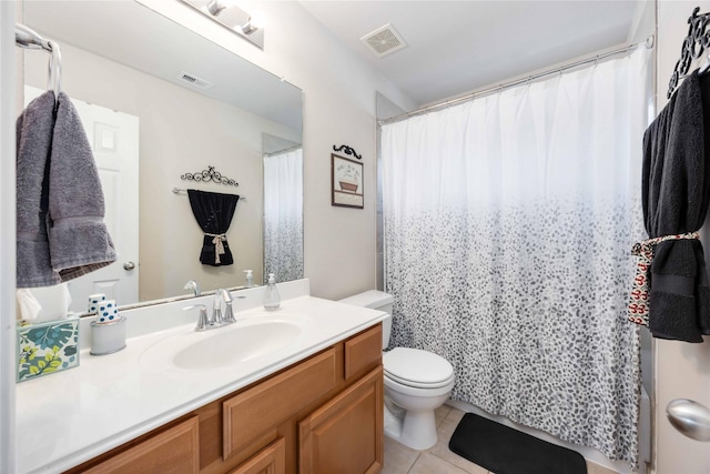 bathroom featuring visible vents, tile patterned floors, toilet, and vanity