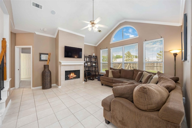 living area with visible vents, a fireplace, baseboards, a ceiling fan, and light tile patterned floors