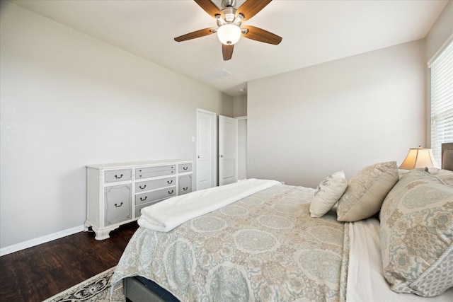 bedroom with baseboards, ceiling fan, dark wood finished floors, and visible vents