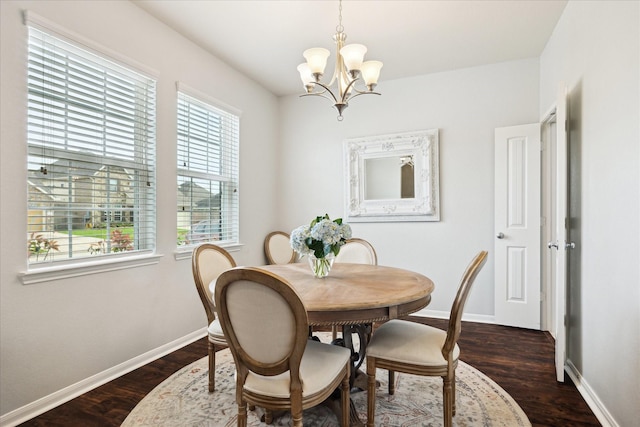 dining room with baseboards, an inviting chandelier, and dark wood finished floors