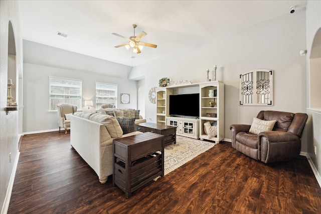 living room with arched walkways, ceiling fan, wood finished floors, and visible vents