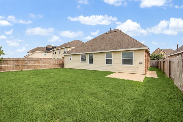 back of house with a lawn, a fenced backyard, and a patio area