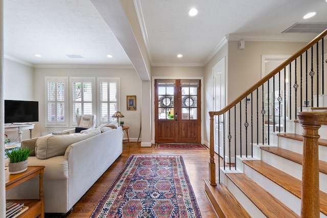 entryway with recessed lighting, baseboards, wood finished floors, and stairway