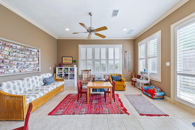 rec room featuring crown molding, ceiling fan, tile patterned flooring, and visible vents