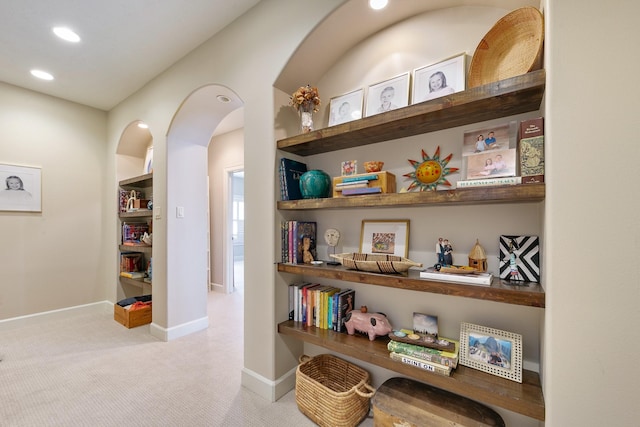 hall featuring recessed lighting, arched walkways, baseboards, and carpet