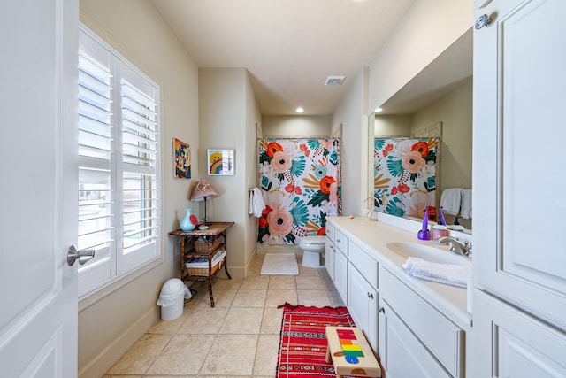 full bathroom featuring vanity, visible vents, toilet, baseboards, and tile patterned floors