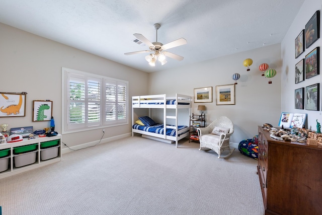 carpeted bedroom with baseboards and a ceiling fan