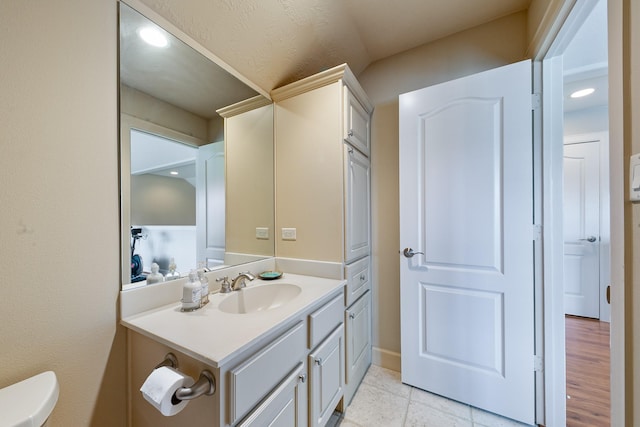 bathroom with toilet, tile patterned floors, recessed lighting, and vanity