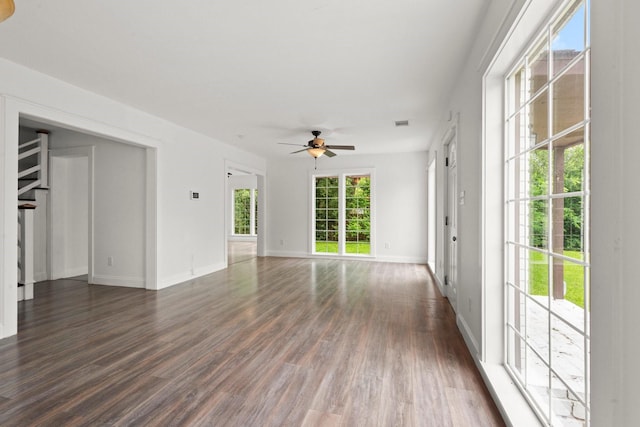 spare room with baseboards, a ceiling fan, dark wood-style flooring, and visible vents