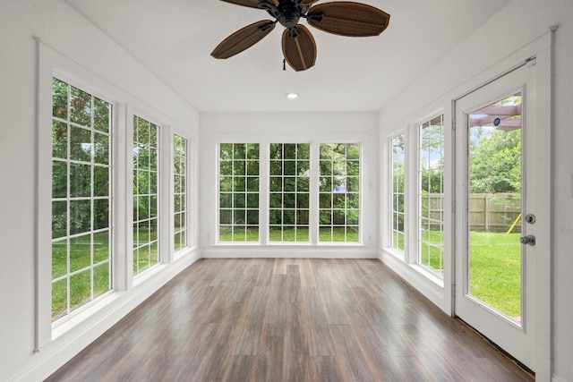 unfurnished sunroom featuring wood finished floors and a healthy amount of sunlight