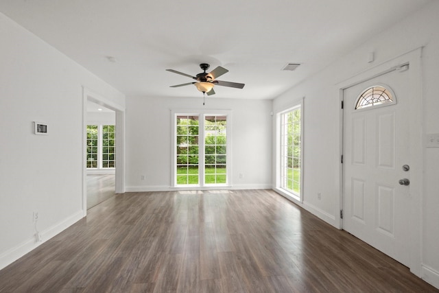 foyer featuring visible vents, dark wood-type flooring, plenty of natural light, and ceiling fan