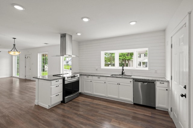 kitchen featuring light stone counters, a sink, extractor fan, stainless steel appliances, and a peninsula