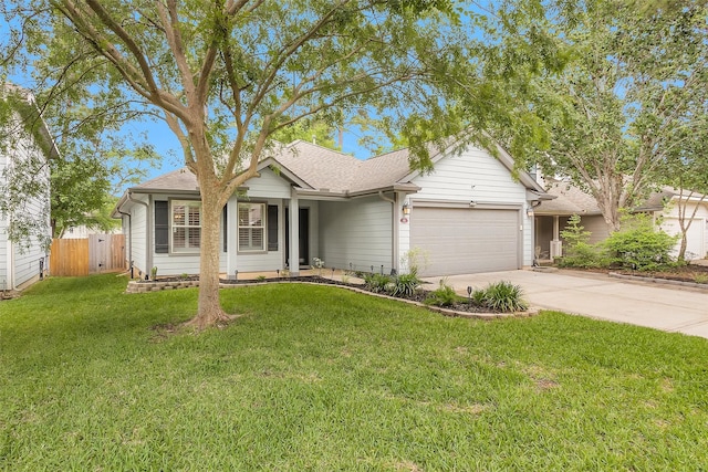 single story home with fence, an attached garage, a shingled roof, a front lawn, and concrete driveway
