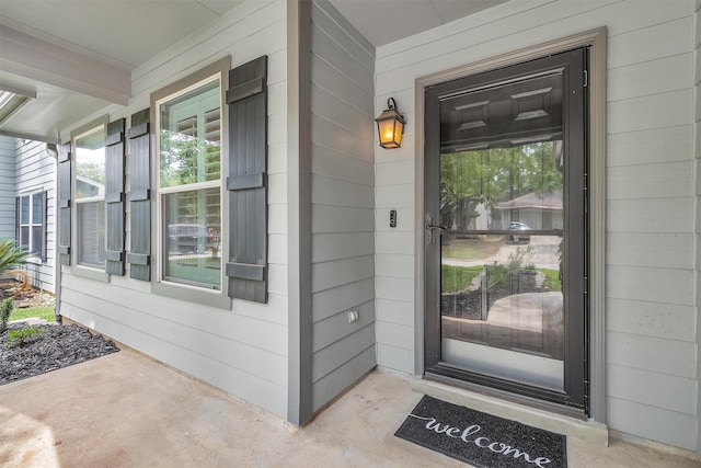 view of exterior entry with a porch
