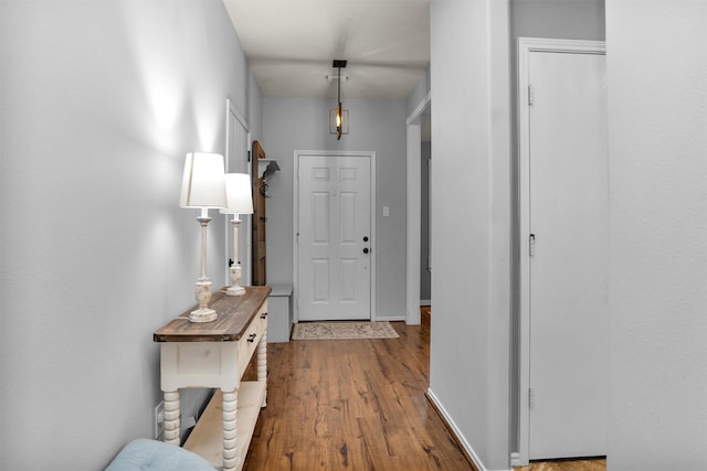 hallway with baseboards and wood finished floors