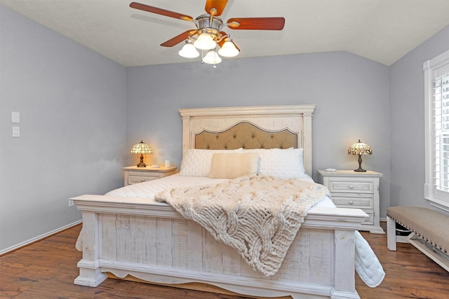 bedroom featuring baseboards, ceiling fan, wood finished floors, and lofted ceiling