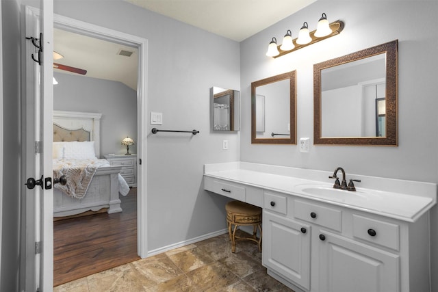 ensuite bathroom with baseboards, vanity, ensuite bath, and visible vents