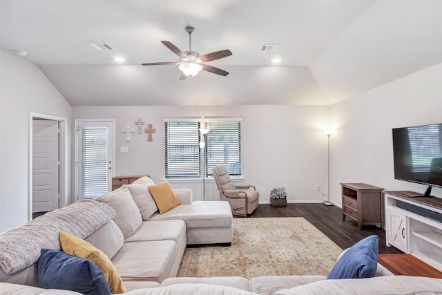 living area featuring visible vents, dark wood-style flooring, baseboards, a ceiling fan, and vaulted ceiling